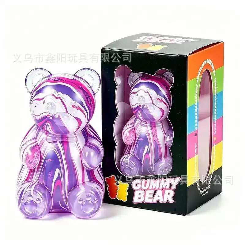 A purple and pink gummy bear squeeze toy in its original box.