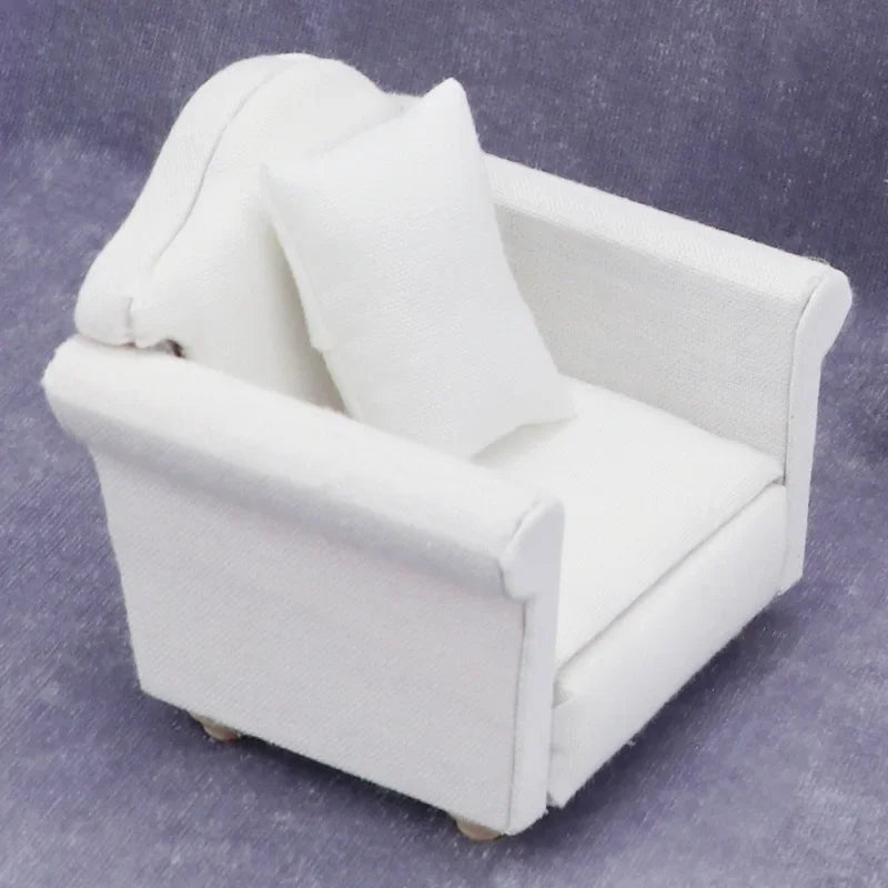 A white 1:12 scale mini sofa and pillow set for a dollhouse