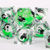A set of green resin sharp edge dice showing various numbers and symbols for tabletop role-playing games