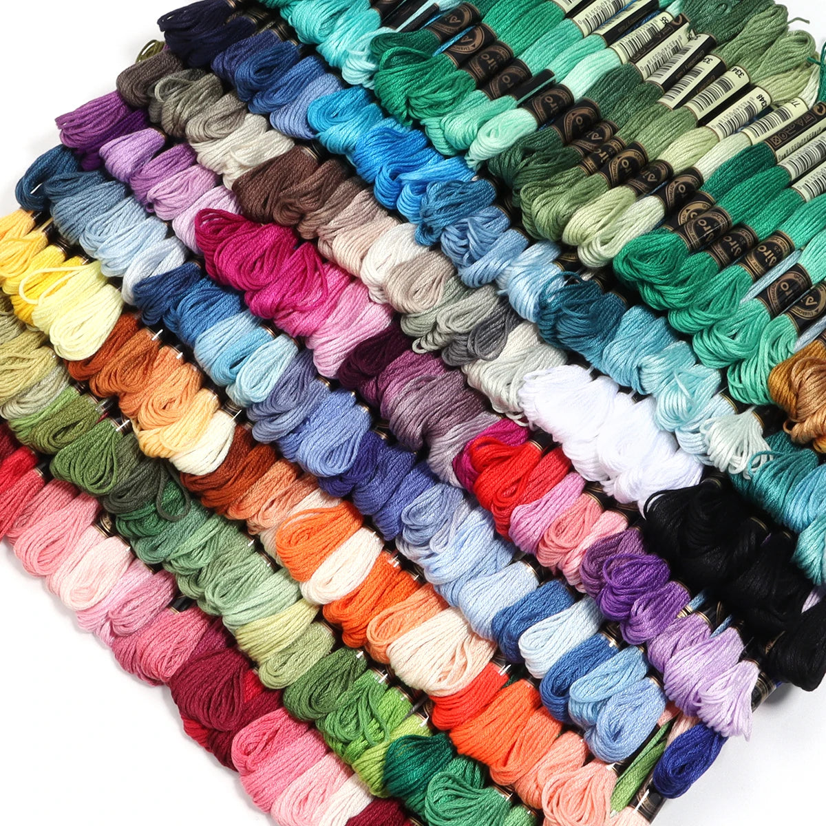 A collection of vibrant embroidery thread skeins in various shades of green, blue, pink, and yellow.