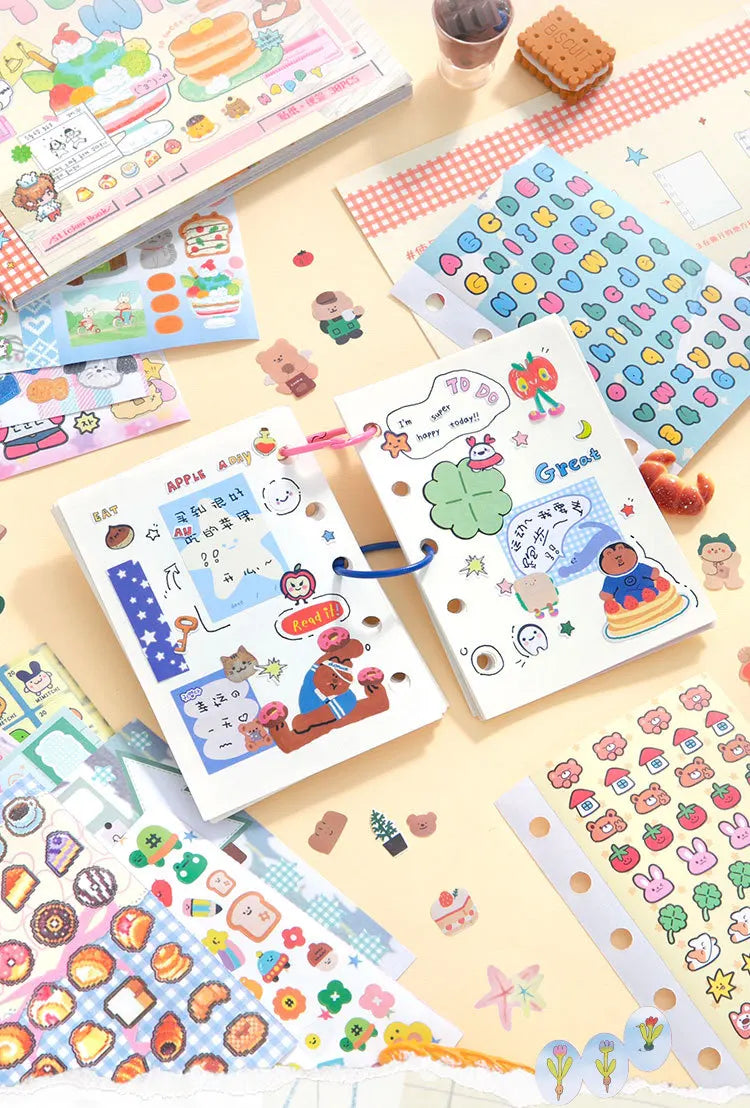 A collection of kawaii cartoon stickers and writable notes for DIY scrapbooking laid out on a light background.