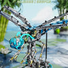 A detailed mechanical model of a dragonfly, featuring silver and blue components, displayed on a green surface.