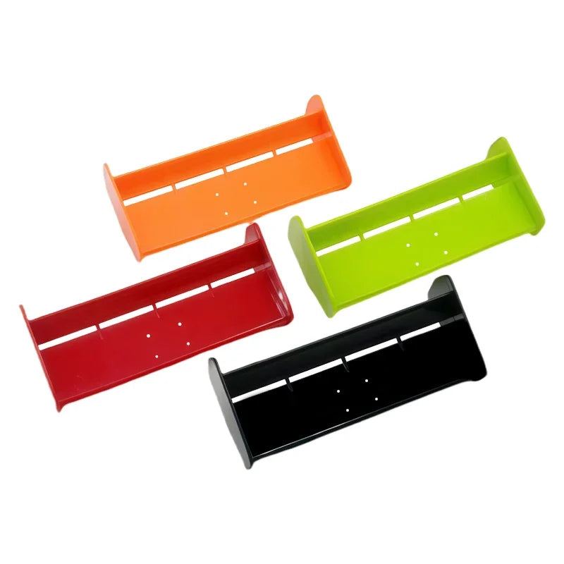 Three plastic hard tail wing upgrades in orange, lime green, and red for RC cars