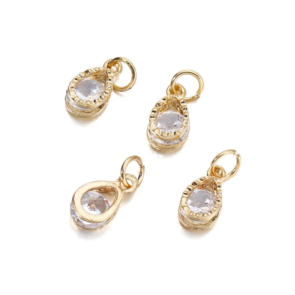 Three gold-toned rhinestone heart charms for jewelry making displayed against a white background.
