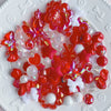 A colorful assortment of red and white acrylic bow and flower beads for DIY jewelry making