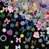 A mix of multicolor aurora resin nail charms including flowers, hearts, and various shapes.