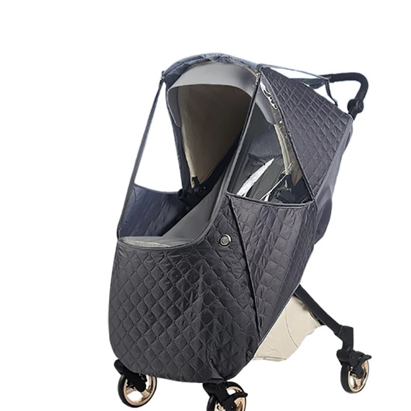 A dark gray quilted stroller cover with a transparent window and black straps.