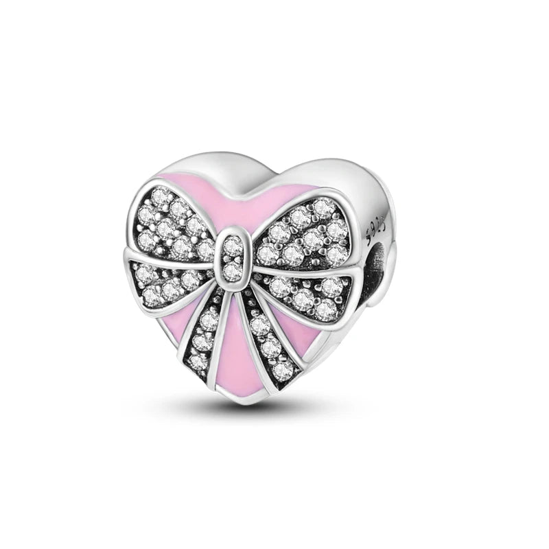 A heart-shaped charm bead made of 925 sterling silver with pink zircon accents.