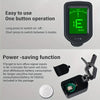 A black clip-on digital tuner with a green display and power-saving features is shown alongside its battery.
