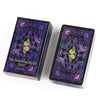 A box of The Wandering Spirit Tarot deck featuring purple and black designs.