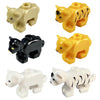 A set of four plastic marine animal building blocks including a yellow shark, octopus, and whale, and two black and white tig