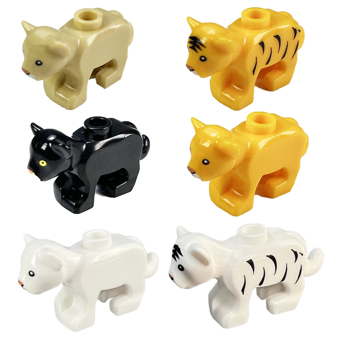 A set of four plastic marine animal building blocks including a yellow shark, octopus, and whale, and two black and white tig