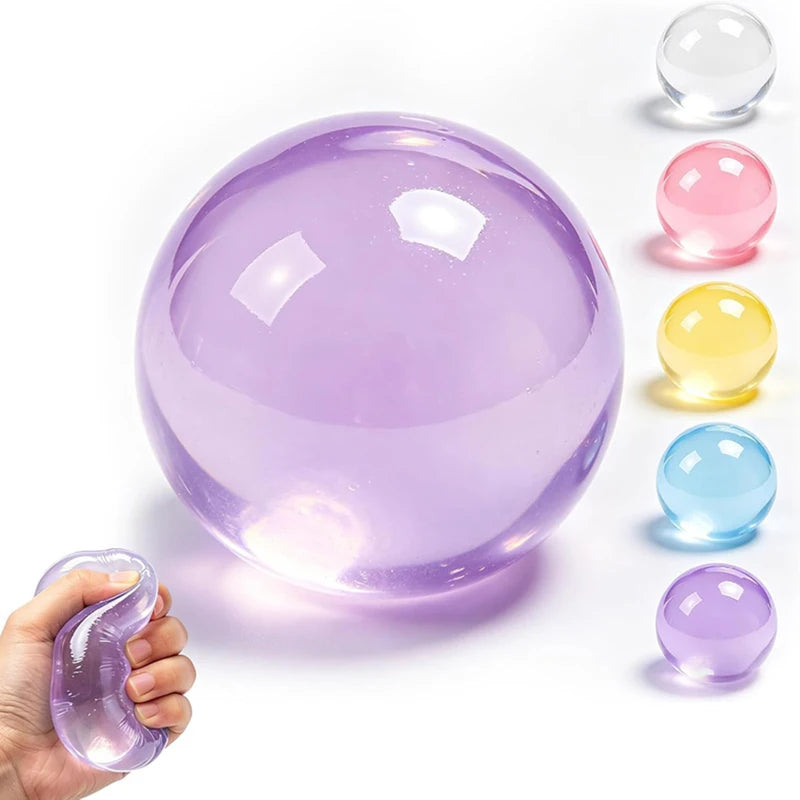 A hand holds a large purple translucent squishy stress ball with smaller colored versions nearby.
