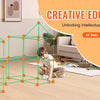 A child is building a geometric structure using green rods and balls for a creative educational toy.