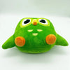 A soft green plush toy of Duo the Owl with large eyes and an orange beak.