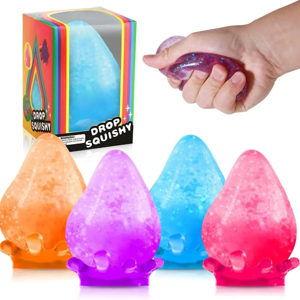 A hand holds a translucent purple sensory stress relief therapy ball next to various colored squishy balls.