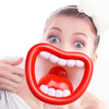 A woman shows her mouth with a red silicone toy to demonstrate a fun voice-changing megaphone for kids and parties.