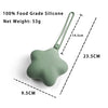 A light green silicone pacifier and teether with a strap, shown from the side.