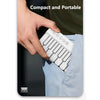 A hand is holding a compact and portable mini piano with white keys, demonstrating its size.