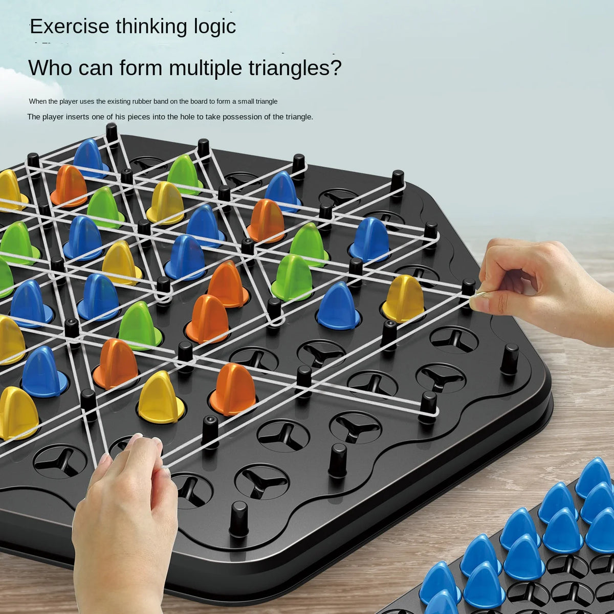A close-up of a black puzzle board game with plastic triangle pieces being inserted to form triangles.