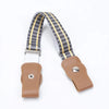 A kids canvas belt with elastic stretch featuring a beige and black striped woven strap and a brown leather buckle.