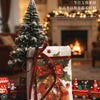 A decorative paper pack featuring Christmas themes and embossed designs, resting on a wooden surface.