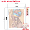 A paint by numbers kit featuring a portrait of a woman in a turban, showing canvas details and color codes.