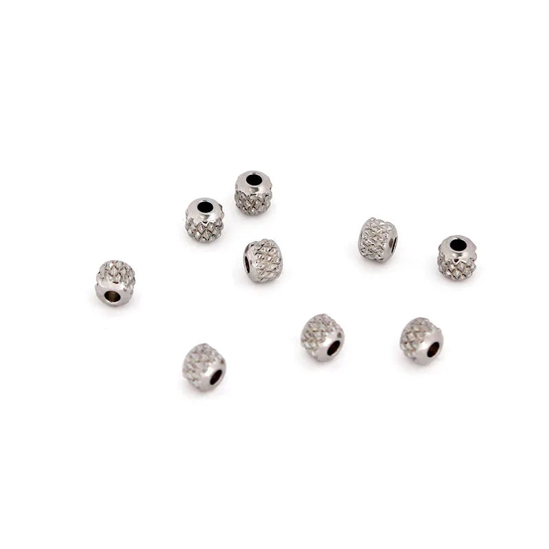 A collection of small, round gold stainless steel spacer beads for jewelry making.
