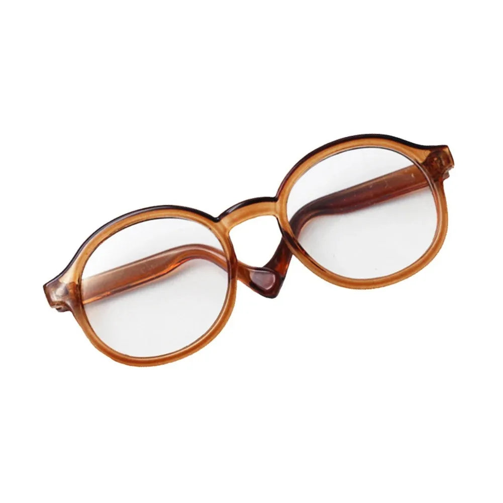 A pair of transparent brown-tinted round glasses for dolls.