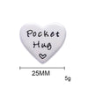A white heart-shaped token for a pocket hug long distance keepsake gift with keychain.