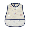 A cream-colored waterproof baby bib with a cartoon sea theme featuring anchors, sailboats, and clouds.
