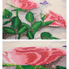 Diamond painting of pink roses and green leaves on a light background