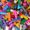 A bulk set of colorful building blocks in various colors including orange, pink, green, blue, and purple.
