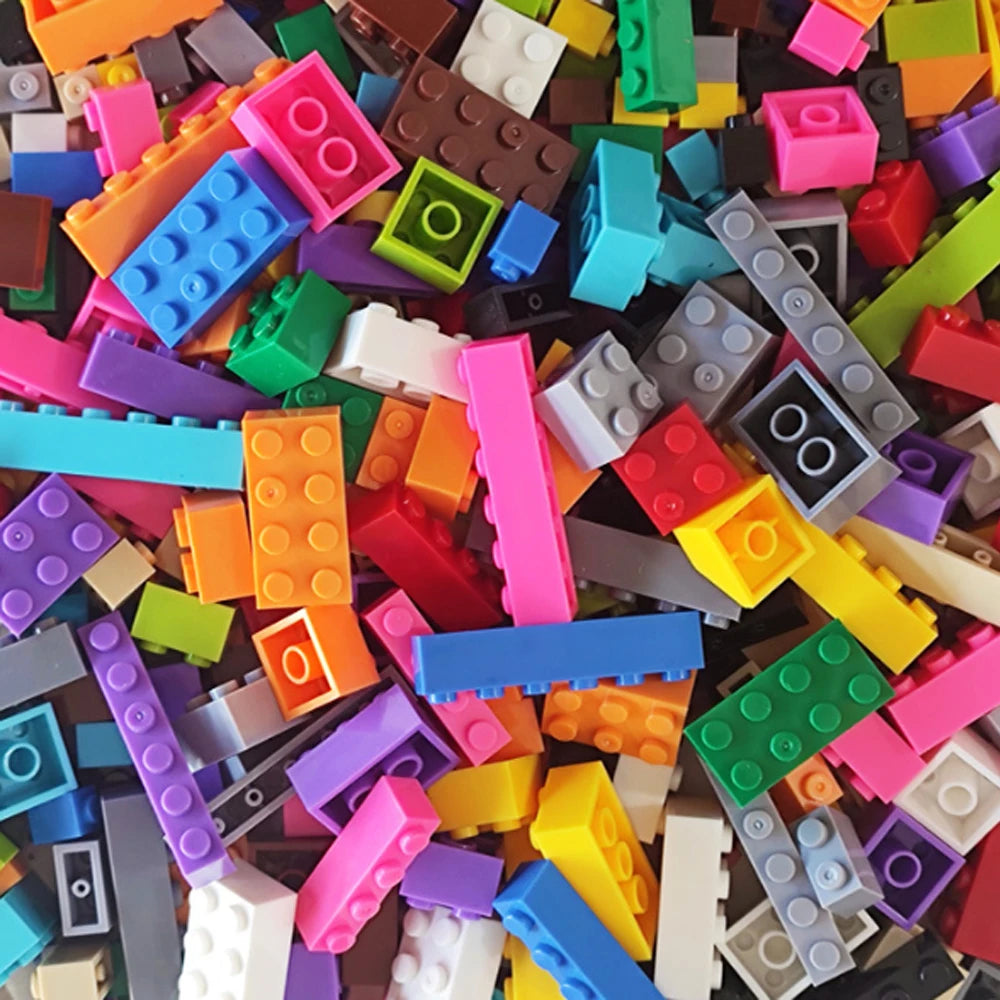 A bulk set of colorful building blocks in various colors including orange, pink, green, blue, and purple.