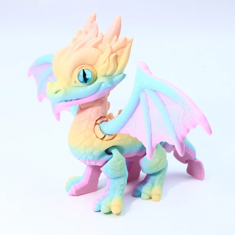 A light orange and teal articulated 3D printed dragon figurine with translucent wings.