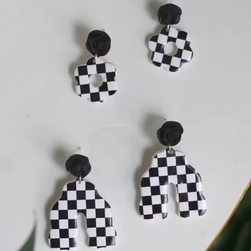 A set of black and white checkered polymer clay blocks used for jewelry making.