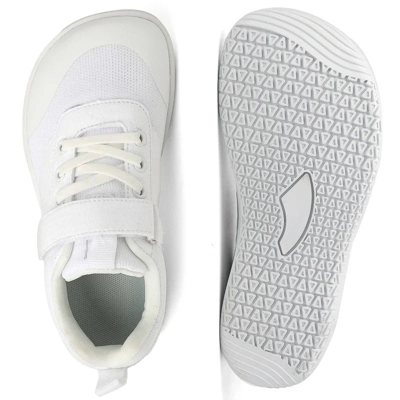 A pair of white minimalist barefoot sneakers shown from the side and bottom view.