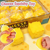 A box of yellow cheese squishy toys is shown alongside a hand squeezing a yellow squishy toy.