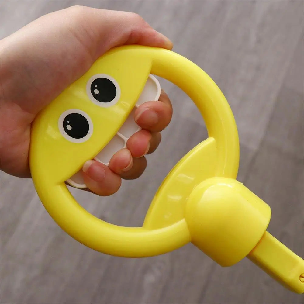A hand holds a yellow bubble wand shaped like a smiling face for kids.