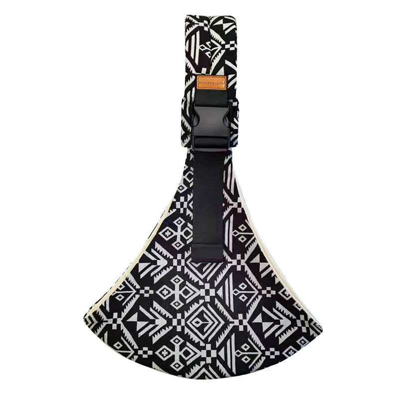 Black and white patterned adjustable baby sling carrier with a brown buckle.