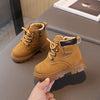 A pair of tan kids' winter leather boots with laces and a side zipper resting on a gray surface.