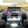 A black and blue 1:14 scale RC monster truck is shown on a dirt road under a bright sky.