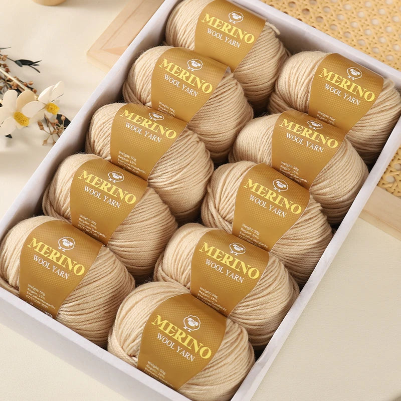 A box filled with spools of Merino wool yarn wrapped in branded paper tags.