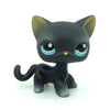 A black and gray Littlest Pet Shop style standing dog figure with large blue eyes.