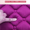 A hand is touching a vibrant purple quilted plush seat cushion, highlighting its texture and softness.