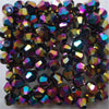 A collection of iridescent, faceted glass bicone beads for jewelry making.