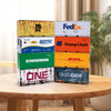 A stack of various colored industrial iron storage boxes, including yellow, white, blue, and green, resting on a wooden table