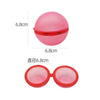 A pink, spherical water balloon with a red sealing mechanism shown next to its size measurement.