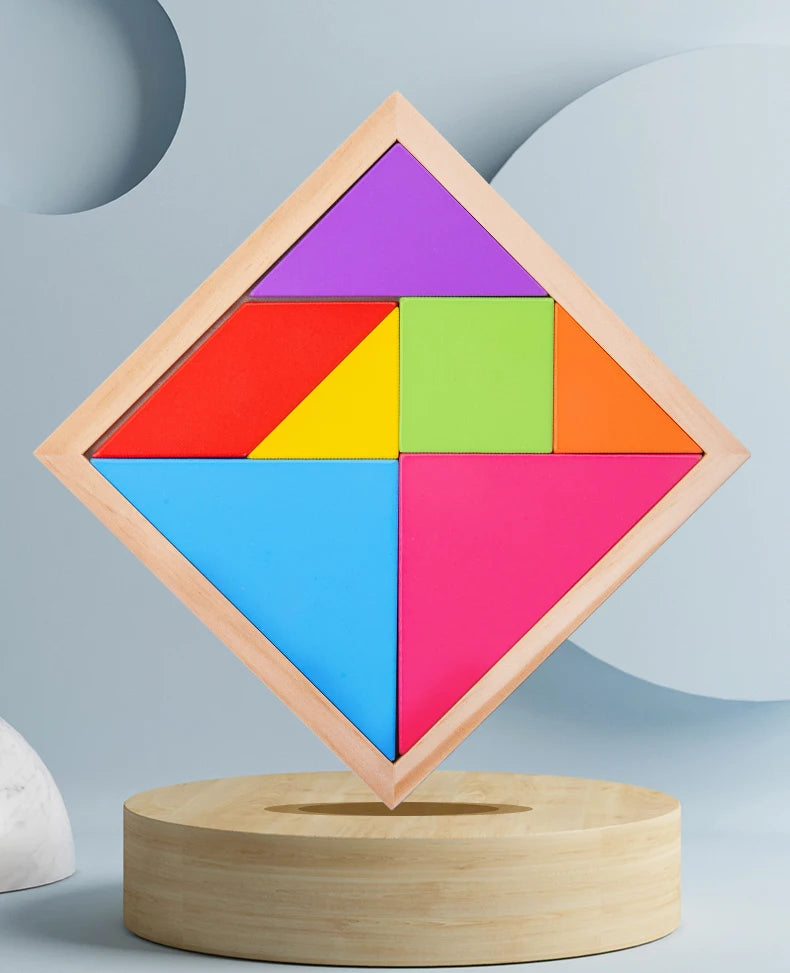 A wooden tangram puzzle set with seven colored pieces arranged in a diamond shape on a light wood base.