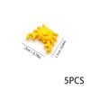 Five yellow plastic marine creature building blocks shown against a white background.